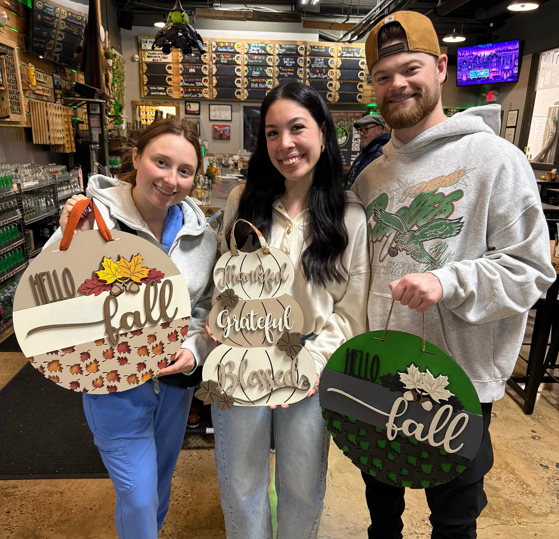 people holding up finished painted signs